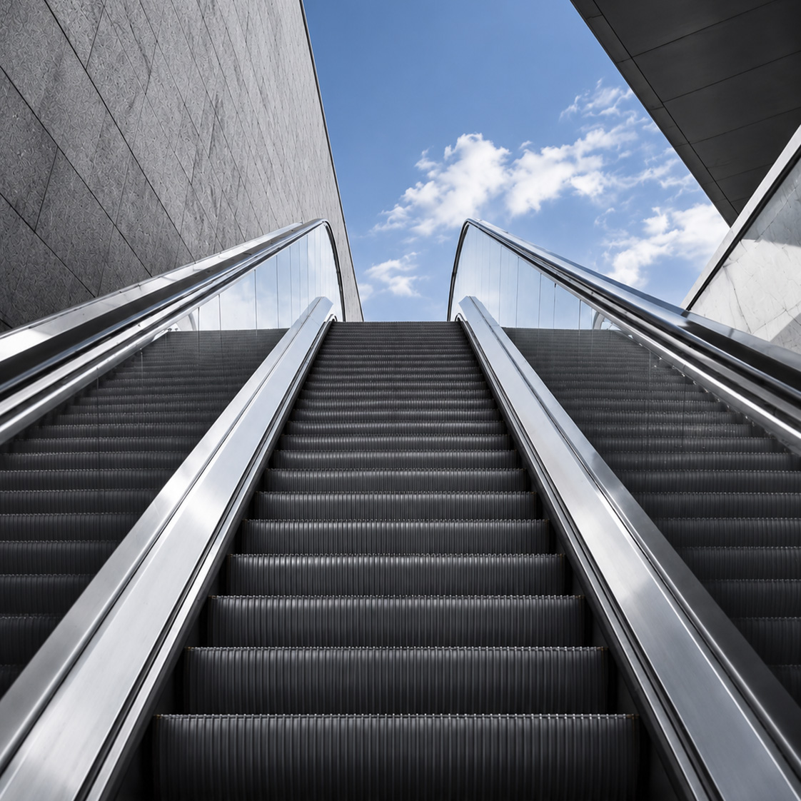 Modern escalators rising between architectural structures, representing AI transformation and business progress