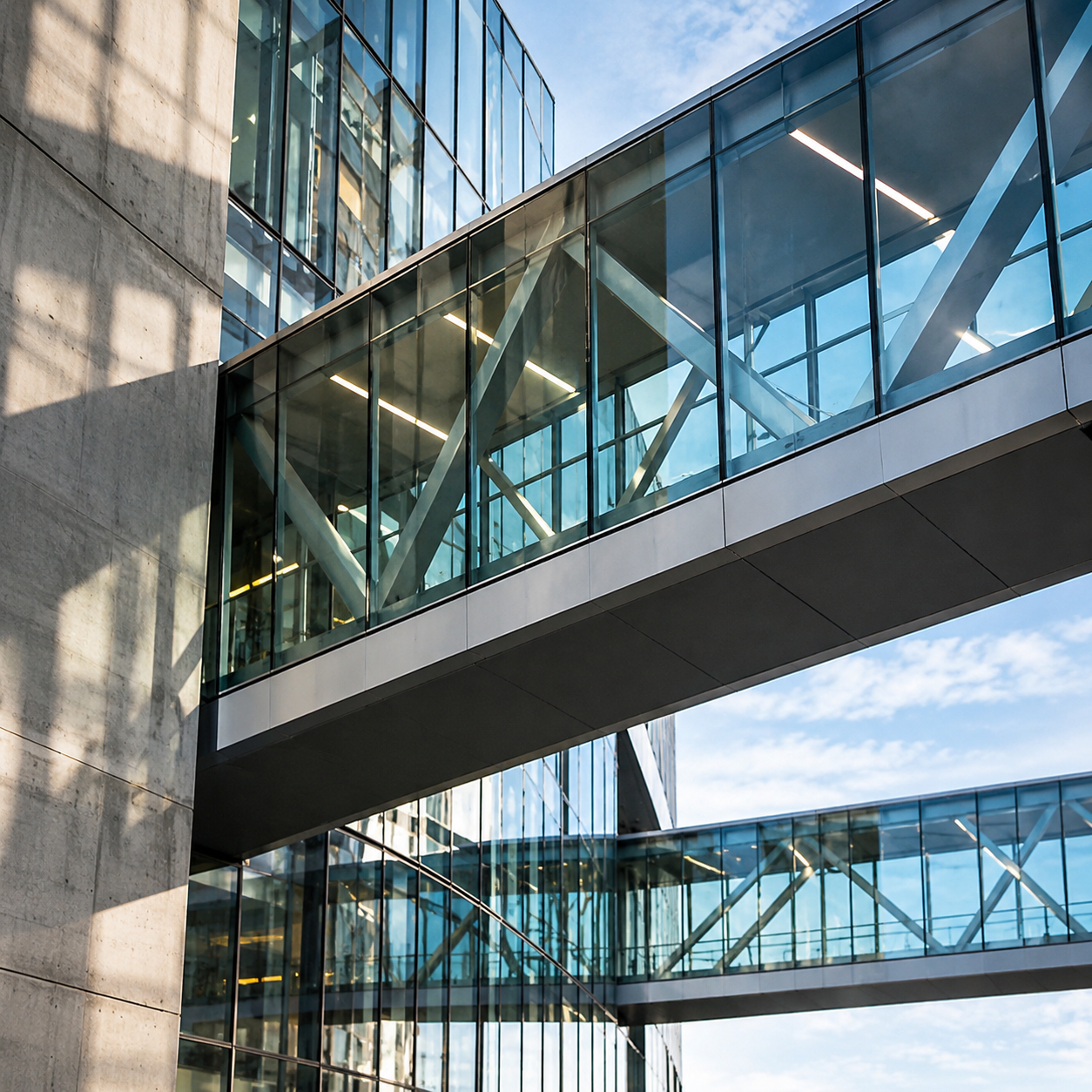 team-ai-agents-enterprise-adoption Architectural photograph of interconnected pedestrian bridges linking separate buildings, representing shared knowledge and collaboration across teams.